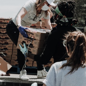 Volunteers unloading boxes of food from a truck